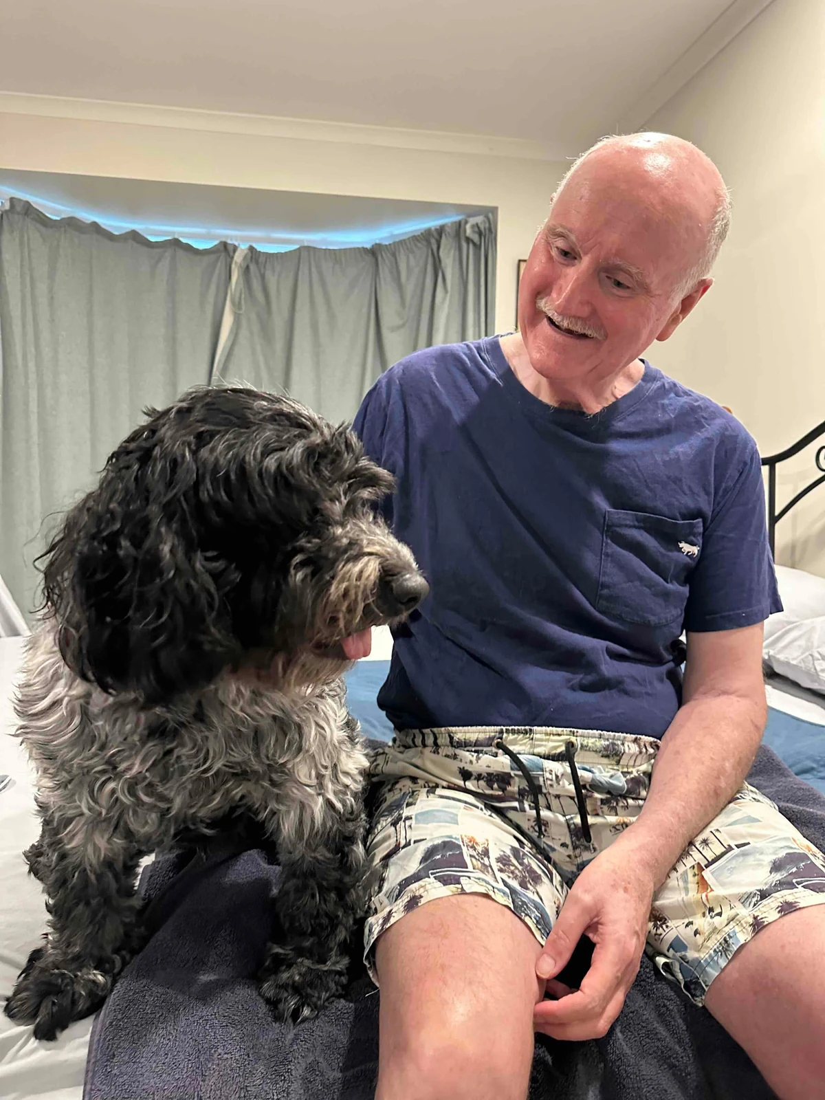John smiling with his dog